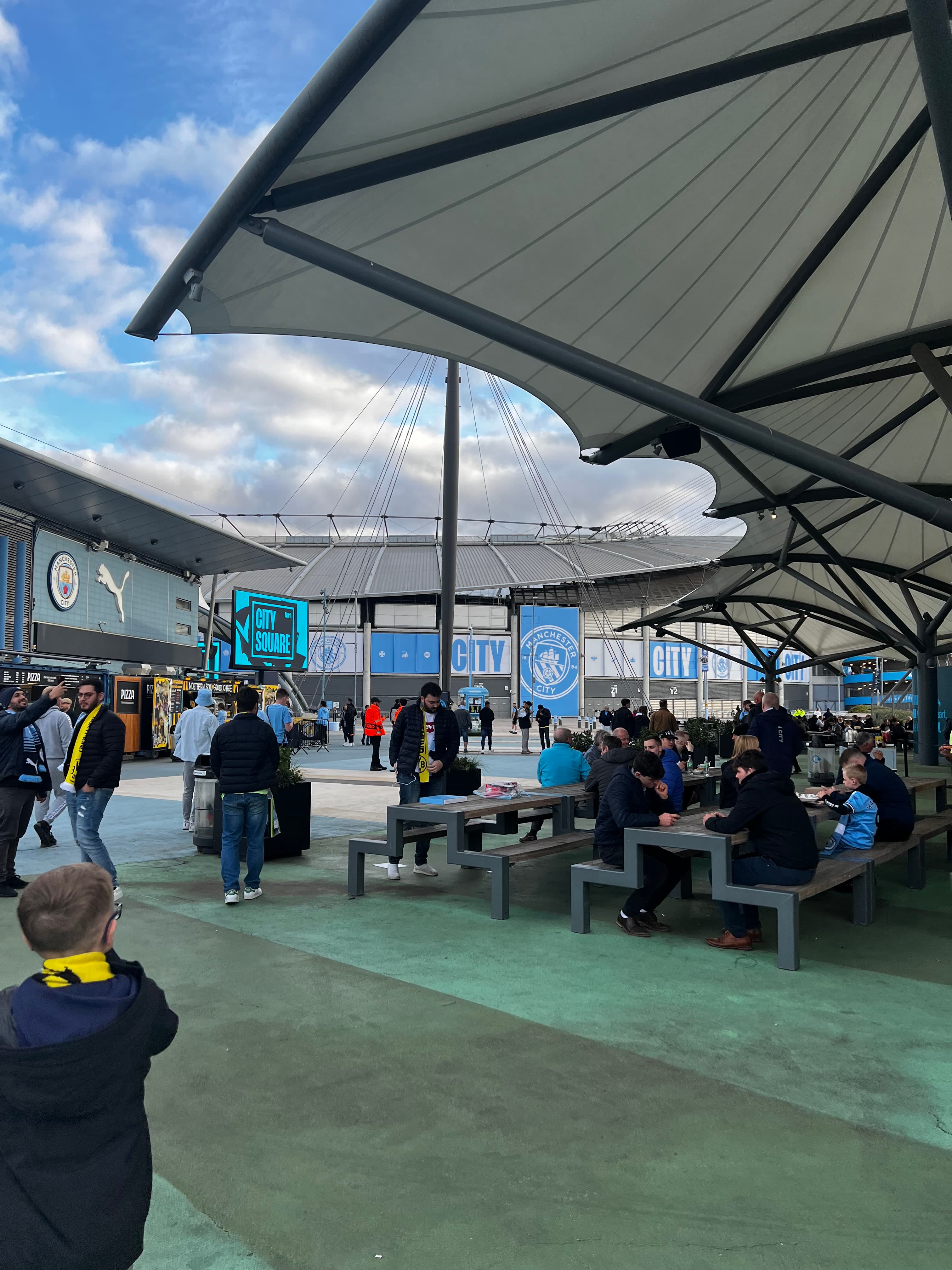Etihad Stadium City Square fan zone Manchester City matchday food stalls seating area Premier League