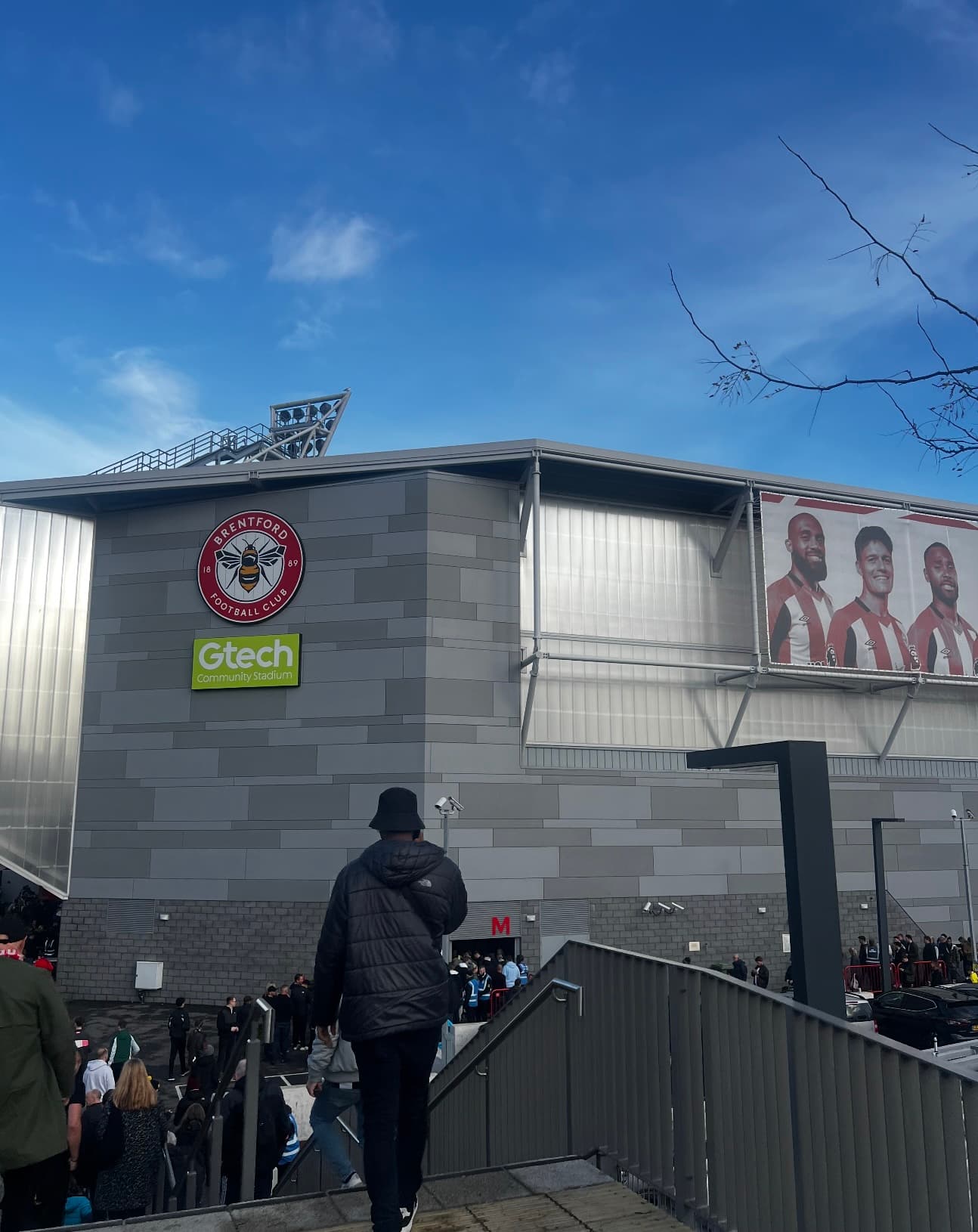 Outside the Gtech Community Stadium with Brentford branding as fans arrive on matchday.